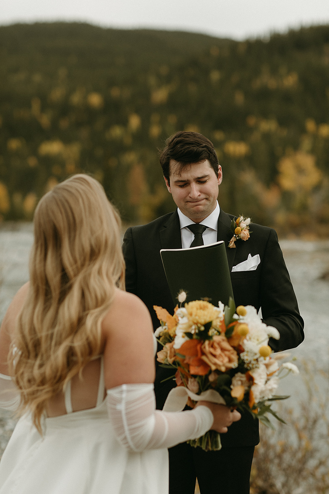 groom crying during private vows by river