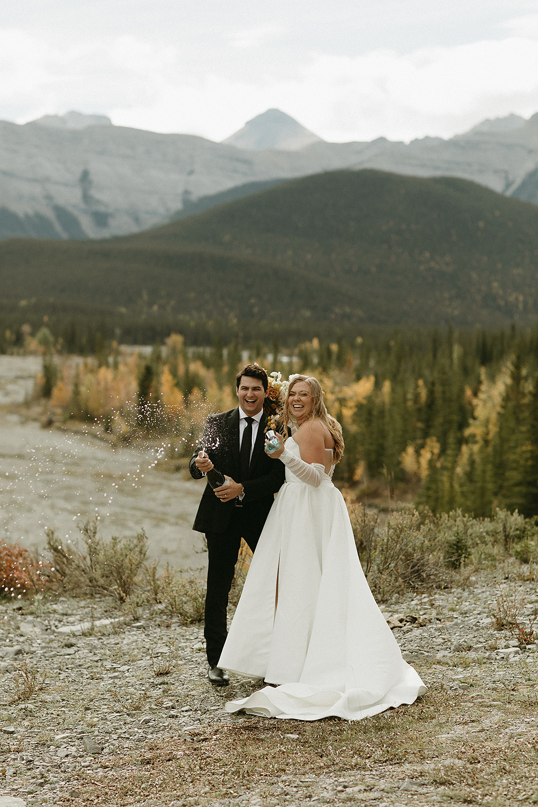 Bragg Creek elopement couple celebrates with champagne pop